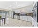 Bright kitchen with white cabinetry, stainless steel appliances, and brick backsplash at 8749 Aruba Ln, Port Richey, FL 34668