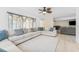The open living area has a large sectional sofa, tile floors, and lots of natural light at 8749 Aruba Ln, Port Richey, FL 34668