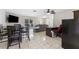 Open-concept living area with tile flooring featuring an office space and a dining set at 8749 Aruba Ln, Port Richey, FL 34668