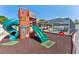 Backyard playground with slide, swing set, and enclosed pool area, creating a fun outdoor space at 8749 Aruba Ln, Port Richey, FL 34668