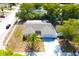 A home with a well maintained gray roof and a driveway, as seen from an aerial view at 9200 Lunar Ln, Port Richey, FL 34668