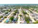 Aerial view of neighborhood showing tree-lined streets and numerous backyard pools at 9200 Lunar Ln, Port Richey, FL 34668