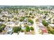 Expansive aerial view of a well-maintained residential community with tree-lined streets and multiple swimming pools at 9200 Lunar Ln, Port Richey, FL 34668