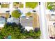 Aerial view of a home in a residential area, showing a neutral roof, nearby trees, and the surrounding street layout at 9200 Lunar Ln, Port Richey, FL 34668