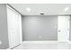Clean basement with marble floors, white doors and neutral walls that create a sense of spaciousness at 9200 Lunar Ln, Port Richey, FL 34668