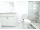Bathroom featuring a shower with elegant marble tiling, a modern sink, and a white toilet at 9200 Lunar Ln, Port Richey, FL 34668