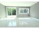 Bedroom featuring natural light, marble floors, neutral colors, and a sliding glass door at 9200 Lunar Ln, Port Richey, FL 34668