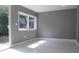 Bedroom featuring natural light from a large window and sliding door, and marble floors at 9200 Lunar Ln, Port Richey, FL 34668