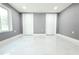 Spacious bedroom with pristine tile flooring and ample closet space at 9200 Lunar Ln, Port Richey, FL 34668