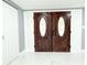 Elegant double front doors with decorative glass inserts, welcoming visitors to this inviting home at 9200 Lunar Ln, Port Richey, FL 34668