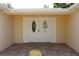 Elegant double front doors with decorative glass inserts, welcoming visitors to this inviting home at 9200 Lunar Ln, Port Richey, FL 34668