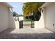 Inviting front courtyard with tiled flooring and a wrought-iron gate, offering a charming entrance to the property at 9200 Lunar Ln, Port Richey, FL 34668