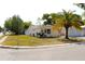 Charming single-story home featuring a well-maintained lawn and a picturesque palm tree in the front yard at 9200 Lunar Ln, Port Richey, FL 34668