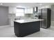 Modern kitchen with island, stainless steel appliances, and bright white cabinetry at 9200 Lunar Ln, Port Richey, FL 34668