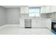 Kitchen featuring white cabinets, stainless steel appliances, and tiled backsplash at 9200 Lunar Ln, Port Richey, FL 34668