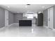 Open-concept kitchen and living area featuring marble floors, and a kitchen island at 9200 Lunar Ln, Port Richey, FL 34668