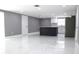 Open-concept living area featuring marble floors, and kitchen with modern island and appliances at 9200 Lunar Ln, Port Richey, FL 34668