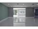 Spacious living room featuring tiled flooring, neutral walls, recessed lighting, and lots of natural light at 9200 Lunar Ln, Port Richey, FL 34668