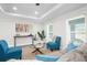 Bright living room with a neutral color palette, natural light, and stylish furnishings at 9482 Noddy Tern Rd, Weeki Wachee, FL 34613