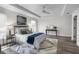 Spacious primary bedroom with a tray ceiling, neutral paint, wood-look floors, and sleek furnishings at 9482 Noddy Tern Rd, Weeki Wachee, FL 34613