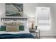 Nicely staged primary bedroom offering a relaxing space with natural light and a decorative art piece over the bed at 9482 Noddy Tern Rd, Weeki Wachee, FL 34613