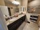 Bathroom featuring a double sink vanity with granite countertops and tiled shower at 954 Old Windsor Way, Spring Hill, FL 34609