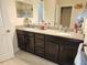 Bathroom showcasing a double sink vanity with granite countertops and tiled flooring at 954 Old Windsor Way, Spring Hill, FL 34609