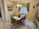 Inviting dining room featuring a modern table, stylish chairs, chandelier, and tasteful decor at 954 Old Windsor Way, Spring Hill, FL 34609