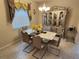 Bright dining room features a sleek table, modern chairs, and a decorative china cabinet at 954 Old Windsor Way, Spring Hill, FL 34609