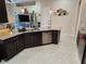 Stylish kitchen showcasing granite countertops, stainless steel appliances, dark cabinets, and a convenient island at 954 Old Windsor Way, Spring Hill, FL 34609