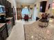 Open-concept kitchen featuring dark cabinetry, stainless steel appliances, granite countertops, and a cozy breakfast nook at 954 Old Windsor Way, Spring Hill, FL 34609