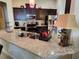 Bright kitchen featuring granite countertops, dark wood cabinets, stainless steel appliances, and ample counter space at 954 Old Windsor Way, Spring Hill, FL 34609