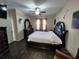 Spacious bedroom showcasing wood-look floors, ceiling fan, large bed, and decorative accents at 954 Old Windsor Way, Spring Hill, FL 34609