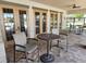 Community outdoor lounge area with table, chairs, and access to pool at 954 Old Windsor Way, Spring Hill, FL 34609