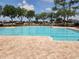 Community pool and lounge area surrounded by trees and landscaping for residents at 954 Old Windsor Way, Spring Hill, FL 34609