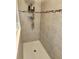 Close-up of tiled shower with tile accents and shower caddy at 954 Old Windsor Way, Spring Hill, FL 34609