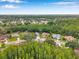 Picturesque aerial view of a serene neighborhood dotted with lush trees and well-maintained homes, exuding tranquility at 9757 Hermosillo Dr, New Port Richey, FL 34655