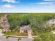 Beautiful aerial view of a well-maintained home with mature trees and verdant landscaping in a tranquil setting at 9757 Hermosillo Dr, New Port Richey, FL 34655