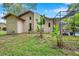 Charming backyard featuring lush landscaping, a screened-in pool enclosure, and exterior home features at 9757 Hermosillo Dr, New Port Richey, FL 34655