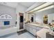 This bathroom features a soaking tub, walk-in shower, and dual vanity sink at 9757 Hermosillo Dr, New Port Richey, FL 34655