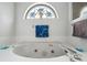 This bathroom features a large soaking tub and a stained-glass window at 9757 Hermosillo Dr, New Port Richey, FL 34655
