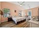 Cozy main bedroom with bright walls, a ceiling fan, and natural light at 9757 Hermosillo Dr, New Port Richey, FL 34655