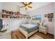Cozy bedroom features a window with bright, natural light and ample shelving at 9757 Hermosillo Dr, New Port Richey, FL 34655