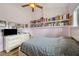 Comfortable bedroom features a ceiling fan, shelving, and dresser with TV at 9757 Hermosillo Dr, New Port Richey, FL 34655