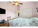 Comfortable bedroom featuring a ceiling fan, closet and TV at 9757 Hermosillo Dr, New Port Richey, FL 34655
