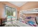 This bedroom has a pool view, wood floors, and built-in bunk beds with a desk at 9757 Hermosillo Dr, New Port Richey, FL 34655