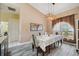 Open-concept dining area with wood-look floors and a large arched window at 9757 Hermosillo Dr, New Port Richey, FL 34655