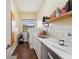 Practical laundry room offers white cabinets, countertop space, and washer/dryer hookups at 9757 Hermosillo Dr, New Port Richey, FL 34655