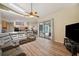 Open-concept living area with hardwood floors and sliding glass doors at 9757 Hermosillo Dr, New Port Richey, FL 34655