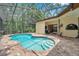 Inviting screened-in pool area with ample deck space, perfect for outdoor relaxation and entertainment at 9757 Hermosillo Dr, New Port Richey, FL 34655